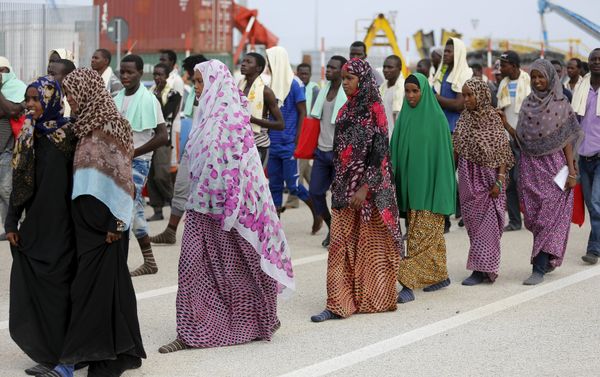 Migrants walk on the dock after disembarking from a Medecins Sans Frontieres ship carrying 320 migrants in the Sicilian harbour of Augusta, Italy, August 25, 2015 - Sputnik International