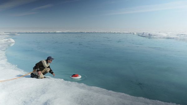 Laurence C. Smith, Chair of Geography at University of California, Los Angeles, deployed an autonomous drifter in a meltwater river on the surface of the Greenland ice sheet on July 19, 2015. Laurence C. Smith, Chair of Geography at University of California, Los Angeles, deployed an autonomous drifter in a meltwater river on the surface of the Greenland ice sheet on July 19, 2015. - Sputnik International