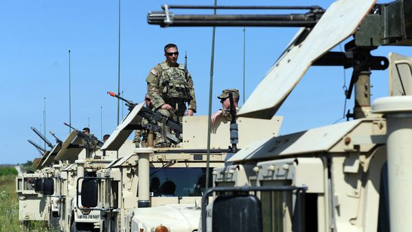 US servicemen stand on humvees with mounted machine guns as they take part in a military drill in Yavoriv polygon, Lviv district, western Ukraine, on July 22, 2015 - Sputnik International