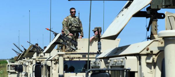 US servicemen stand on humvees with mounted machine guns as they take part in a military drill in Yavoriv polygon, Lviv district, western Ukraine, on July 22, 2015 US servicemen stand on humvees with mounted machine guns as they take part in a military drill in Yavoriv polygon, Lviv district, western Ukraine, on July 22, 2015 - Sputnik International