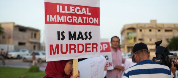In this Thursday, Aug. 27, 2015 photo, local residents hold a demonstration against illegal immigration after hearing news that a boat carrying hundreds of migrants capsized off the coast, in Zuwara, Libya - Sputnik International
