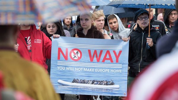 People take part at a demonstration initiated by right-wing NPD (National Democratic Party of Germany) against the German asylum law and asylum seekers in Riesa, eastern Germany, Tuesday, Aug. 18, 2015 People take part at a demonstration initiated by right-wing NPD (National Democratic Party of Germany) against the German asylum law and asylum seekers in Riesa, eastern Germany, Tuesday, Aug. 18, 2015 - Sputnik International