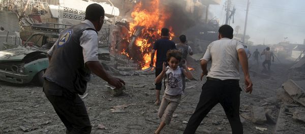 A boy runs as he rushes away from a site hit by what activists said were airstrikes by forces loyal to Syria's President Bashar al-Assad in the Douma neighborhood of Damascus, Syria August 24, 2015 A boy runs as he rushes away from a site hit by what activists said were airstrikes by forces loyal to Syria's President Bashar al-Assad in the Douma neighborhood of Damascus, Syria August 24, 2015 - Sputnik International