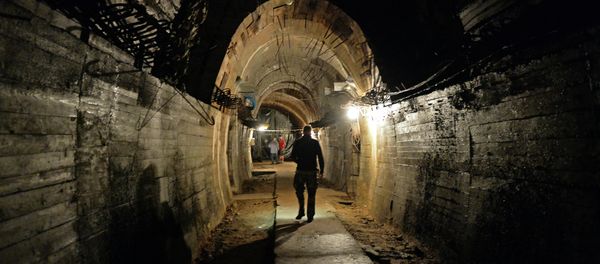 Men walk in underground galeries, part of Nazi Germany Riese construction project under the Ksiaz castle in the area where the Nazi gold train is supposedly hidden underground, on August 28, 2015 in Walbrzych, Poland. - Sputnik International