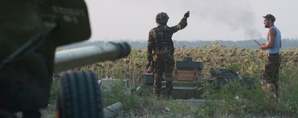 In this photo taken on Thursday, Aug. 14, 2014, a Ukrainian government soldier points on a smoke after shelling near Illovaisk, Donetsk region, eastern Ukraine In this photo taken on Thursday, Aug. 14, 2014, a Ukrainian government soldier points on a smoke after shelling near Illovaisk, Donetsk region, eastern Ukraine - Sputnik International