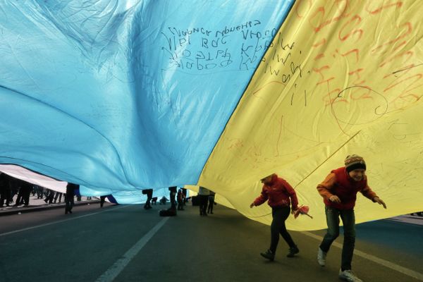Ukrainian kids play under a huge yellow-and-blue Ukrainian national flag at a rally in Kiev's Independent square, Ukraine, Saturday, April 5, 2014 Ukrainian kids play under a huge yellow-and-blue Ukrainian national flag at a rally in Kiev's Independent square, Ukraine, Saturday, April 5, 2014 - Sputnik International