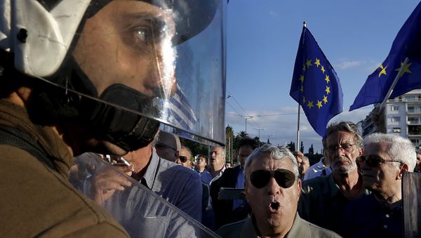 Riot police stand between anti-austerity and pro-EU protesters in front of the parliament building during a rally calling on the government to clinch a deal with its international creditors and secure Greece's future in the eurozone in Athens, Greece, in this June 22, 2015 file photo Riot police stand between anti-austerity and pro-EU protesters in front of the parliament building during a rally calling on the government to clinch a deal with its international creditors and secure Greece's future in the eurozone in Athens, Greece, in this June 22, 2015 file photo - Sputnik International