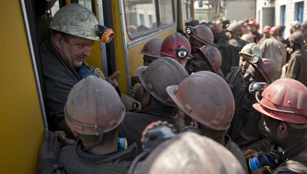 Ukrainian coal miners jokingly block a colleague from the next shift from getting off a bus at a coal mine outside Donetsk, Ukraine Ukrainian coal miners jokingly block a colleague from the next shift from getting off a bus at a coal mine outside Donetsk, Ukraine - Sputnik International