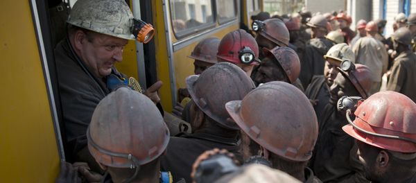 Ukrainian coal miners jokingly block a colleague from the next shift from getting off a bus at a coal mine outside Donetsk, Ukraine Ukrainian coal miners jokingly block a colleague from the next shift from getting off a bus at a coal mine outside Donetsk, Ukraine - Sputnik International