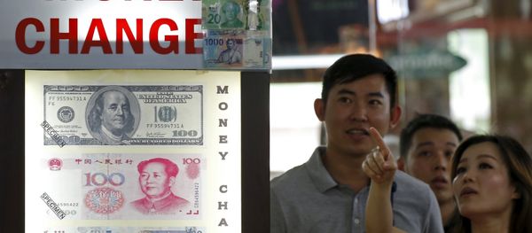 People look at the exchange rate at a moneychanger displaying a poster of U.S. dollar bill, Chinese Yuan and Malaysia Ringgit in Singapore People look at the exchange rate at a moneychanger displaying a poster of U.S. dollar bill, Chinese Yuan and Malaysia Ringgit in Singapore - Sputnik International