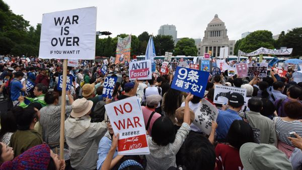 People shout slogans as they hold banners during an anti-government rally in front of the National Diet in Tokyo People shout slogans as they hold banners during an anti-government rally in front of the National Diet in Tokyo - Sputnik International
