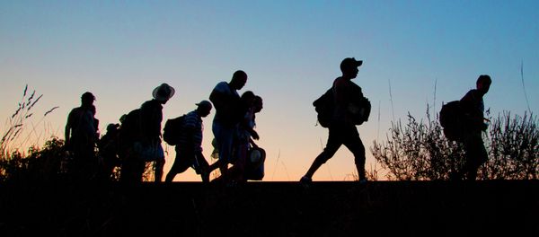 A group of refugees walk on the railway tracks after crossing from Serbia, into Roszke, Hungary, Tuesday, Sept. 1, 2015. A group of refugees walk on the railway tracks after crossing from Serbia, into Roszke, Hungary, Tuesday, Sept. 1, 2015. - Sputnik International