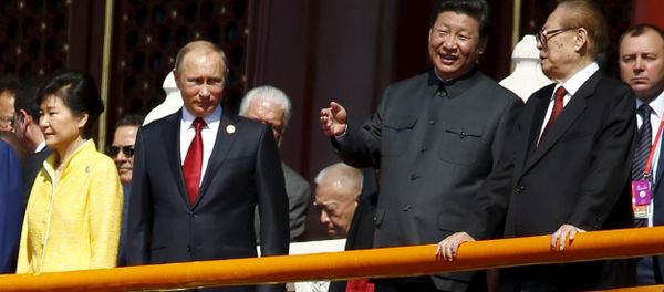 Chinese President Xi Jinping (2nd R) talks to former President Jiang Zemin (R) next to Russia's President Vladimir Putin (2nd L) and South Korea's President Park Geun-hye on the Tiananmen Gate, at the beginning of the military parade marking the 70th anniversary of the end of World War Two, in Beijing, China, September 3, 2015 Chinese President Xi Jinping (2nd R) talks to former President Jiang Zemin (R) next to Russia's President Vladimir Putin (2nd L) and South Korea's President Park Geun-hye on the Tiananmen Gate, at the beginning of the military parade marking the 70th anniversary of the end of World War Two, in Beijing, China, September 3, 2015 - Sputnik International
