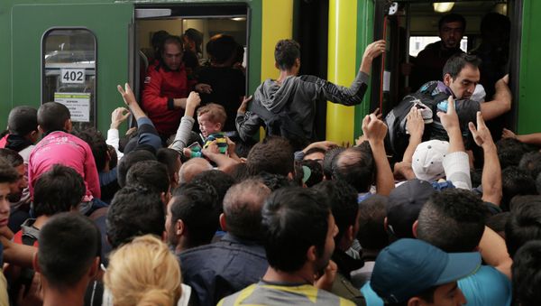 A young child cries as hundreds of migrants try to board a train at the Keleti Railway Station in Budapest, Hungary, Thursday, Sept. 3, 2015 A young child cries as hundreds of migrants try to board a train at the Keleti Railway Station in Budapest, Hungary, Thursday, Sept. 3, 2015 - Sputnik International