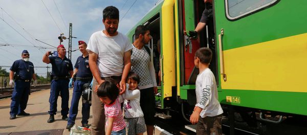 Migrants stand outside a train at the railway station in the town of Bicske, Hungary, September 3, 2015 Migrants stand outside a train at the railway station in the town of Bicske, Hungary, September 3, 2015 - Sputnik International