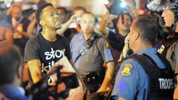 A protester (L) speaks emotionally at a police officer during a protest down a street in Ferguson, Missouri on August 19, 2014 A protester (L) speaks emotionally at a police officer during a protest down a street in Ferguson, Missouri on August 19, 2014 - Sputnik International