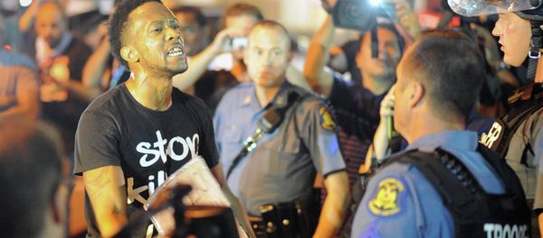 A protester (L) speaks emotionally at a police officer during a protest down a street in Ferguson, Missouri on August 19, 2014 A protester (L) speaks emotionally at a police officer during a protest down a street in Ferguson, Missouri on August 19, 2014 - Sputnik International