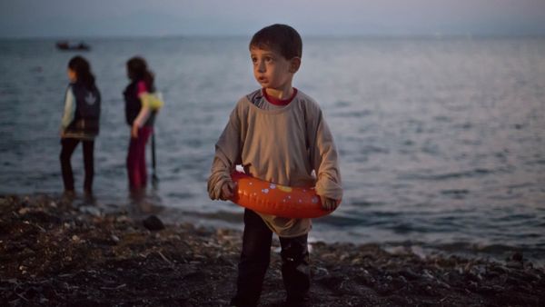 A Syrian migrant boy still wearing a swimming ring stands on the beach upon his arrival with other migrants by a dinghy at the southeastern Greek island of Kos, Greece, early Thursday, Aug. 20, 2015. A Syrian migrant boy still wearing a swimming ring stands on the beach upon his arrival with other migrants by a dinghy at the southeastern Greek island of Kos, Greece, early Thursday, Aug. 20, 2015. - Sputnik International