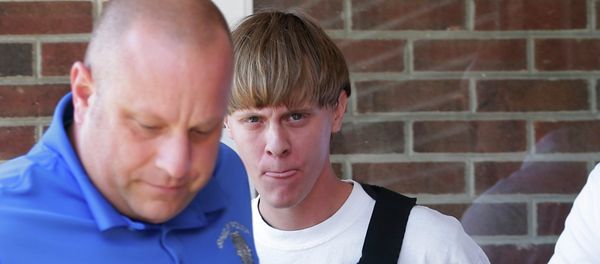 FILE - In this June 18, 2015, file photo, Charleston, S.C., shooting suspect Dylann Storm Roof, center, is escorted from the Sheby Police Department in Shelby, N.C. - Sputnik International
