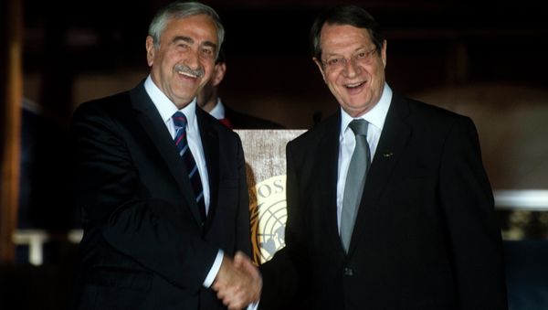 Cypriot President Nicos Anastasiades (R) shakes the hand of Turkish Cypriot President of the self-proclaimed Turkish Republic of Northern Cyprus (TRNC), Mustafa Akinci, following a UN-sponsored meeting at Ledra palace on May 11, 2015 - Sputnik International