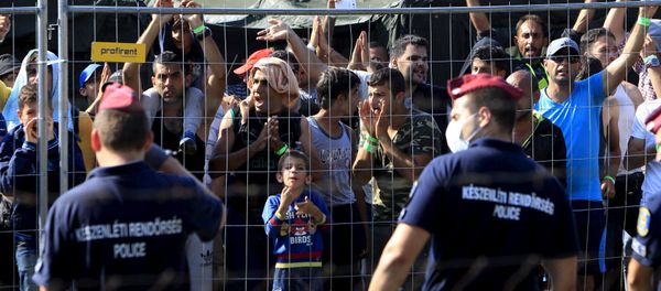 Syrian migrants shout slogans at a refugee camp in Roszke, Hungary, August 28, 2015 Syrian migrants shout slogans at a refugee camp in Roszke, Hungary, August 28, 2015 - Sputnik International