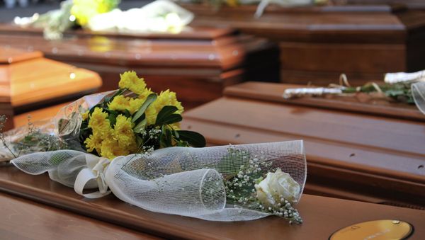 Flowers lay on top of coffins with the remains of 13 migrants who were among up to 800 people who died in a shipwreck in April, in Catania, Sicily, Italy, Tuesday, July 7, 2015 Flowers lay on top of coffins with the remains of 13 migrants who were among up to 800 people who died in a shipwreck in April, in Catania, Sicily, Italy, Tuesday, July 7, 2015 - Sputnik International