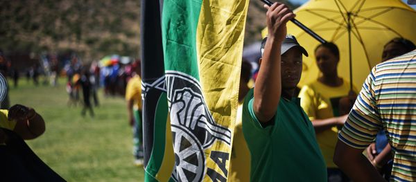 A man holds an African National Congress flag as South African ruling party African National Congress supporters gather to listen to President Jacob Zuma delivering a speech during an Election campaign rally at Umasizakhe stadium in the Eastern Cape city of Graaf-Reinet on April 10, 2014 A man holds an African National Congress flag as South African ruling party African National Congress supporters gather to listen to President Jacob Zuma delivering a speech during an Election campaign rally at Umasizakhe stadium in the Eastern Cape city of Graaf-Reinet on April 10, 2014 - Sputnik International
