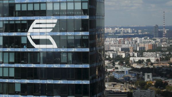 The logo of VTB Group is seen through a window of Imperia Tower on the facade of the Federatsiya (Federation) Tower at the Moscow International Business Center also known as Moskva-City, in Moscow, Russia, in this August 5, 2015 file photo - Sputnik International