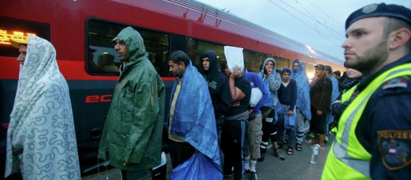 Migrants board a train to Germany at the Austrian train station of Nickelsdorf, September 5, 2015 Migrants board a train to Germany at the Austrian train station of Nickelsdorf, September 5, 2015 - Sputnik International