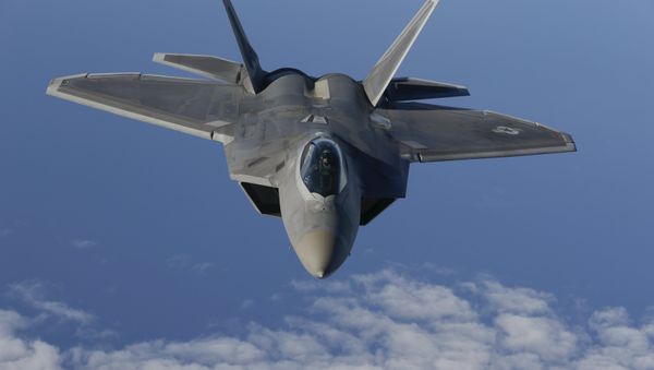 A F-22 Raptor fighter jet of the 95th Fighter Squadron from Tyndall, Florida approaches a KC-135 Stratotanker from the 100th Air Refueling Wing at the Royal Air Force Base in Mildenhall in Britain as they fly over the Baltic Sea towards the newly established NATO airbase of Aemari, Estonia September 4, 2015. - Sputnik International
