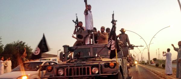 FILE - In this photo taken Monday, June 23, 2014, fighters from the Islamic State group parade in a commandeered Iraqi security forces armored vehicle down a main road at the northern city of Mosul, Iraq - Sputnik International