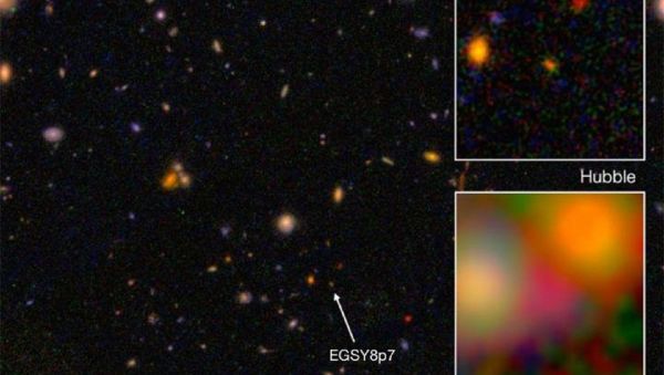This is galaxy EGS8p7, as seen from the Hubble Space Telescope (wide and top right) and Spitzer Space Telescope (inset, bottom right), taken in infrared. - Sputnik International