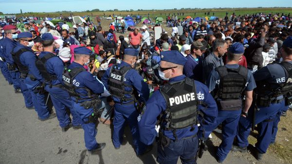 Migrants are controlled by police officers at a refugee collection point near the Hungarian-Serbian border of Roszke village on September 7, 2015 Migrants are controlled by police officers at a refugee collection point near the Hungarian-Serbian border of Roszke village on September 7, 2015 - Sputnik International