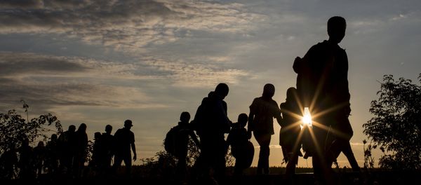 Migrants walk along rail tracks as they arrive at a collection point in the village of Roszke, Hungary, September 8, 2015 Migrants walk along rail tracks as they arrive at a collection point in the village of Roszke, Hungary, September 8, 2015 - Sputnik International