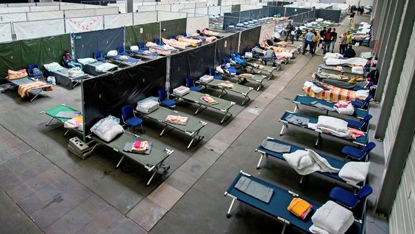 Refugees and migrants arrive in their accommodation, the exhibition halls of the Trade Fair Messe Erfurt, in Erfurt, central Germany, Tuesday, Sept. 8, 2015. The city of Erfurt expect up to 600 migrants to arrive within some hours. - Sputnik International