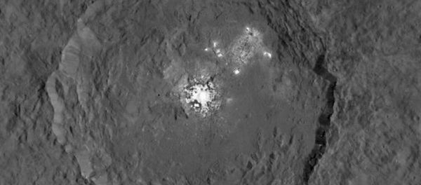 Occator Crater on dwarf planet Ceres, seen from orbit of 915 miles Occator Crater on dwarf planet Ceres, seen from orbit of 915 miles - Sputnik International