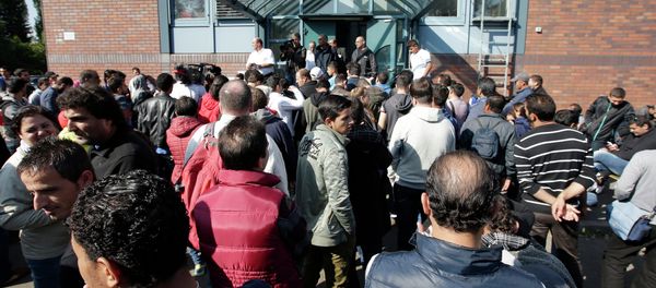 People wait outside a registration center for migrants and refugees in Berlin, Germany, Thursday, Sept. 10, 2015. - Sputnik International