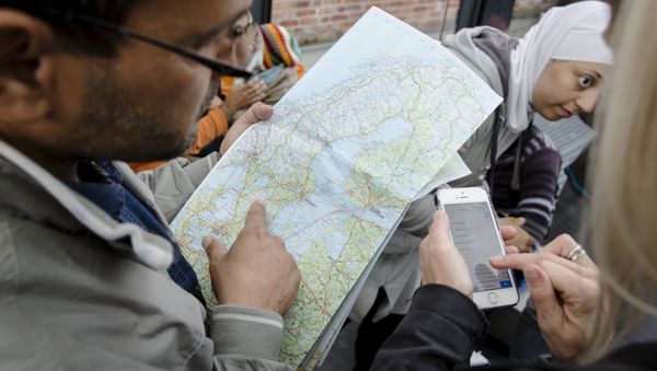 A migrant checks a map of Sweden after arriving at Malmo train station in Sweden September 10, 2015. A migrant checks a map of Sweden after arriving at Malmo train station in Sweden September 10, 2015. - Sputnik International