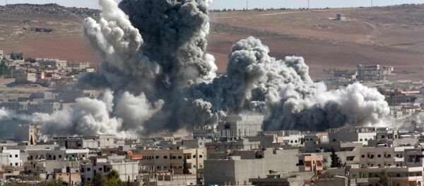 In this Oct. 22, 2014, file photo, thick smoke from an airstrike by the US-led coalition rises in Kobani, Syria, as seen from a hilltop on the outskirts of Suruc, at the Turkey-Syria border In this Oct. 22, 2014, file photo, thick smoke from an airstrike by the US-led coalition rises in Kobani, Syria, as seen from a hilltop on the outskirts of Suruc, at the Turkey-Syria border - Sputnik International