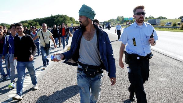Migrants walk north on the highway in Southern Denmark, Wednesday, Sept. 9, 2015 Migrants walk north on the highway in Southern Denmark, Wednesday, Sept. 9, 2015 - Sputnik International