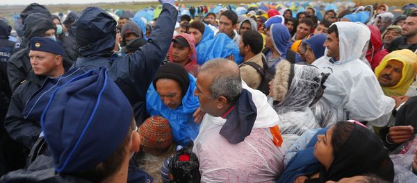 Migrants queue to board a bus at a collection point in Roszke, Hungary September 10, 2015 Migrants queue to board a bus at a collection point in Roszke, Hungary September 10, 2015 - Sputnik International