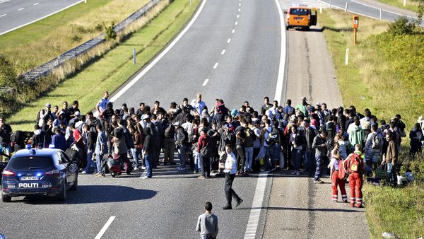 A group of refugees and migrants who were walking north stand on the highway in southern Denmark on Wednesday, Sept. 9, 2015 A group of refugees and migrants who were walking north stand on the highway in southern Denmark on Wednesday, Sept. 9, 2015 - Sputnik International