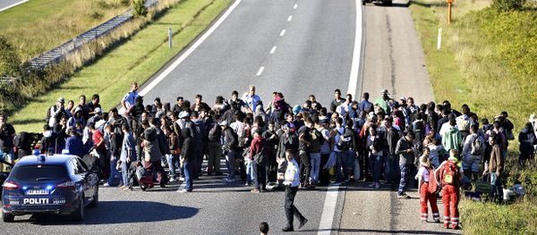 A group of refugees and migrants who were walking north stand on the highway in southern Denmark on Wednesday, Sept. 9, 2015 A group of refugees and migrants who were walking north stand on the highway in southern Denmark on Wednesday, Sept. 9, 2015 - Sputnik International