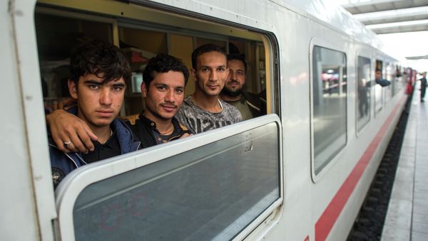 Friends Ibrahim, Hamayoun and Nomi, from left, refugees from Afghanistan, travel in a special train to Dortmund, photographed at the central train station in Munich, Germany, Friday Sept. 11, 2015. Friends Ibrahim, Hamayoun and Nomi, from left, refugees from Afghanistan, travel in a special train to Dortmund, photographed at the central train station in Munich, Germany, Friday Sept. 11, 2015. - Sputnik International