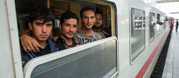 Friends Ibrahim, Hamayoun and Nomi, from left, refugees from Afghanistan, travel in a special train to Dortmund, photographed at the central train station in Munich, Germany, Friday Sept. 11, 2015. Friends Ibrahim, Hamayoun and Nomi, from left, refugees from Afghanistan, travel in a special train to Dortmund, photographed at the central train station in Munich, Germany, Friday Sept. 11, 2015. - Sputnik International