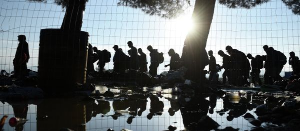 The sun rises as refugees and migrants walk to pass from the northern Greek village of Idomeni to southern Macedonia, Friday, Sept. 11, 2015. The sudden onset of autumn has taken tens of thousands by surprise all along the Balkans route from Greece to Hungary The sun rises as refugees and migrants walk to pass from the northern Greek village of Idomeni to southern Macedonia, Friday, Sept. 11, 2015. The sudden onset of autumn has taken tens of thousands by surprise all along the Balkans route from Greece to Hungary - Sputnik International