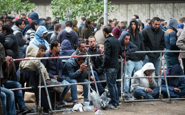 Refugees and migrants wait outside the Berlin State Office for Health and Social Affairs in Berlin, Germany, Friday Sept. 11, 2015 Refugees and migrants wait outside the Berlin State Office for Health and Social Affairs in Berlin, Germany, Friday Sept. 11, 2015 - Sputnik International