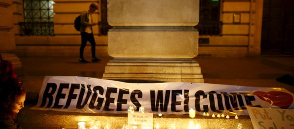 A woman lights a candle during a vigil for refugees in Nottingham, Britain, September 7, 2015 - Sputnik International