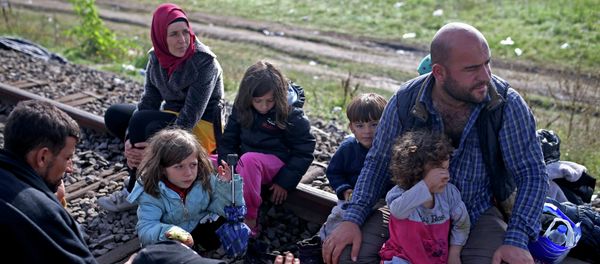 Migrants take a rest after crossing into the country from Serbia at the border near Roszke, Hungary September 12, 2015 - Sputnik International