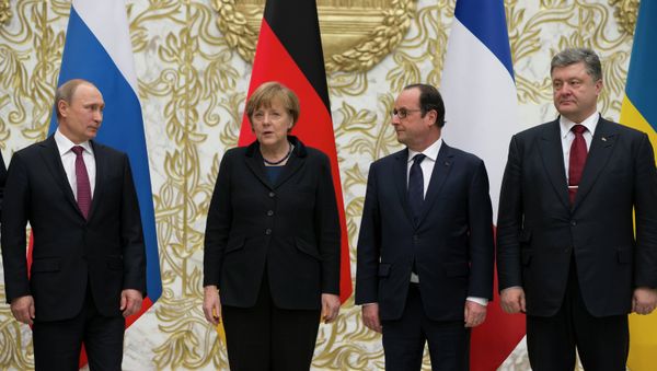 From the left : Russian President Vladimir Putin, German Chancellor Angela Merkel, French President Francois Hollande, and Ukrainian President Petro Poroshenko pose for a photo during a time-break in their peace talks in Minsk, Belarus, Wednesday, Feb. 11, 2015. Leaders of Russia, Ukraine, France and Germany are gathering for crucial talks in the hope of negotiating an end fighting between Russia-backed separatist and government forces in eastern Ukraine. - Sputnik International